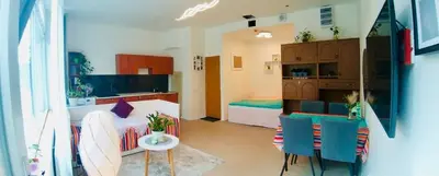 a room with a bed and a table and chairs at Green Studio Praha 2 l Ground floor Free PARKING in Prague