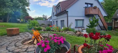 a garden with flowers in front of a house at Votice Luční in Wotitz