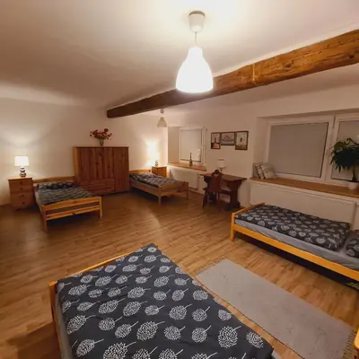 a living room with two beds and a table at Votice Luční in Wotitz