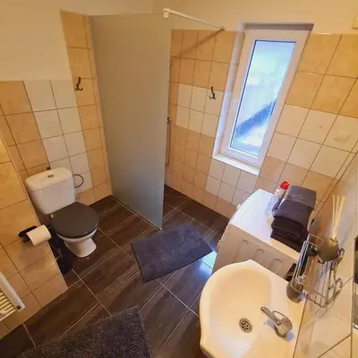 a bathroom with a sink and a toilet and a window at Votice Luční in Wotitz