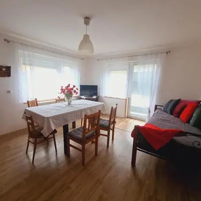 a dining room with a table and chairs and a bed at Votice Luční in Wotitz