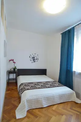 a bedroom with two beds and a window at Modern Apartment Navrátilova II in Prague