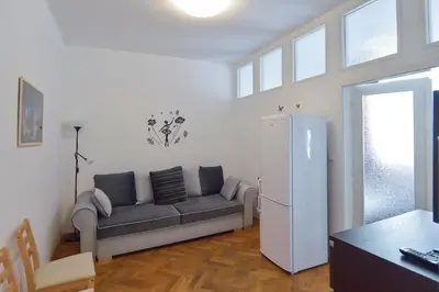 a living room with a couch and a refrigerator at Modern Apartment Navrátilova II in Prague