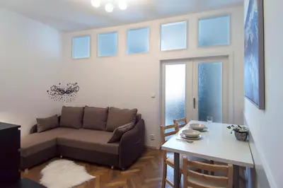 a living room with a couch and a table at Modern Apartment Navrátilova II in Prague