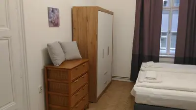 a bedroom with a bed and a dresser and a mirror at Modern Apartment Perlova in Prague