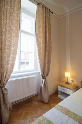 a bedroom with a bed and a large window at Modern Apartment Perlova in Prague