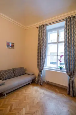 a living room with a couch and a window at Modern Apartment Perlova in Prague