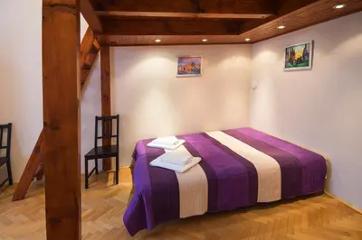 a bedroom with a bed with a purple blanket at Modern Apartment Perlova in Prague