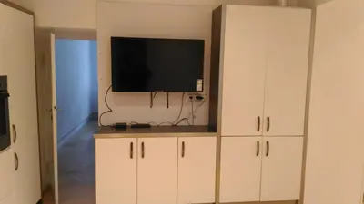 a white cabinet with a television on top of it at Modern Apartment Perlova in Prague