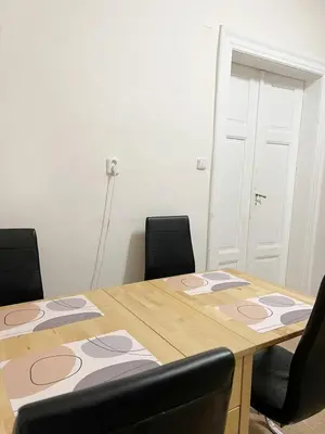 a table with two chairs and a wooden table at Modern Apartment Krakovska in Prague