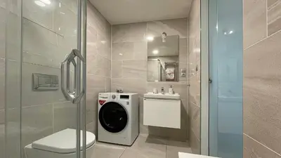 a bathroom with a washing machine and a toilet at Matilda108 in Prague