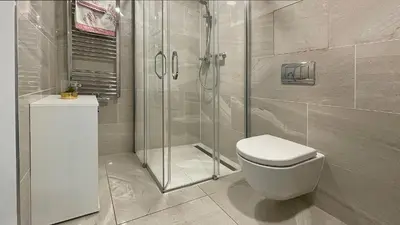 a bathroom with a toilet and a glass shower at Matilda108 in Prague
