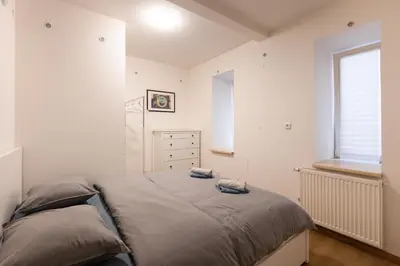 a bedroom with a bed and a dresser at Spacious apartment in quiet courtyard near Charles Bridge in Prague