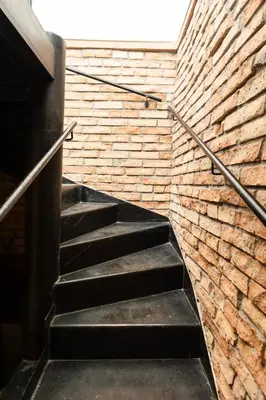 a stairway leading to a brick wall at Spacious apartment in quiet courtyard near Charles Bridge in Prague