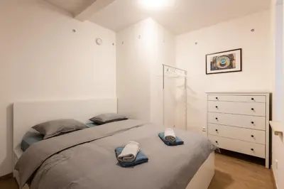 a bedroom with a bed with towels on it at Spacious apartment in quiet courtyard near Charles Bridge in Prague
