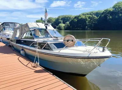 a boat is docked at a dock on the water at Wake Port Boat, ubytování na lodi in Brandýs nad Labem-Stará Boleslav
