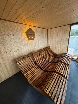 a wooden bench in a boat with a sign at Wake Port Boat, ubytování na lodi in Brandýs nad Labem-Stará Boleslav