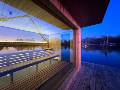 a bridge over a lake with a bench on a dock at Wake Port Boat, ubytování na lodi in Brandýs nad Labem-Stará Boleslav