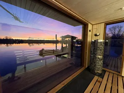 a window of a house with a view of the water at Wake Port Boat, ubytování na lodi in Brandýs nad Labem-Stará Boleslav
