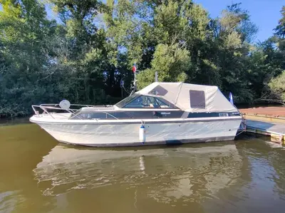 a white boat is parked on the water at Wake Port Boat, ubytování na lodi in Brandýs nad Labem-Stará Boleslav