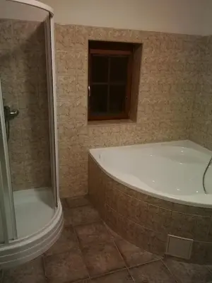 a bathroom with a shower and a bath tub at Vila Barrandovská patro 2 in Prague