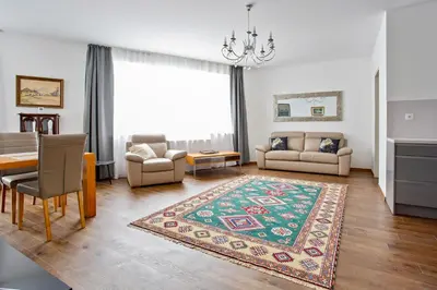 a living room with a table and a dining room at Melody in Prague