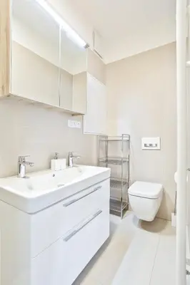 a white bathroom with a sink and a toilet at Melody in Prague