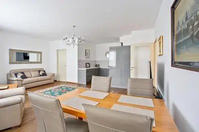 a dining room and living room with a table and chairs at Melody in Prague