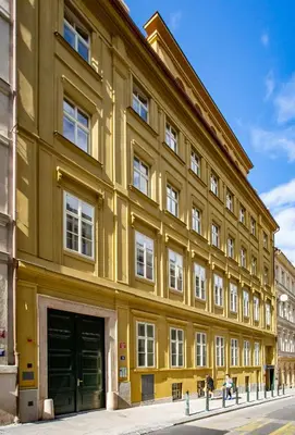 a large yellow building on a street at Melody in Prague