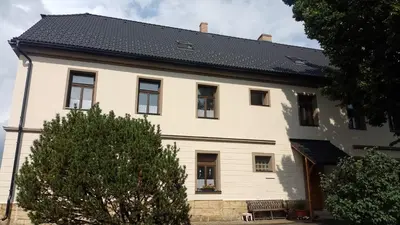 a white house with a black roof at Ubytování Ždírec - Apartmán 1 in Ždírec