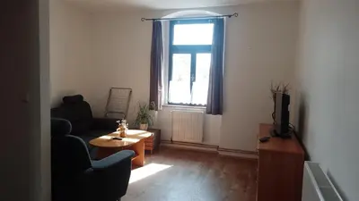 a living room with a couch and a table and a window at Ubytování Ždírec - Apartmán 1 in Ždírec