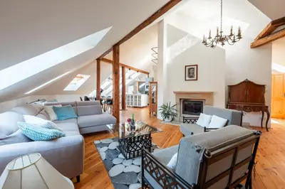 a living room with couches and a fireplace at Spacious apartments near National theatre in Prague