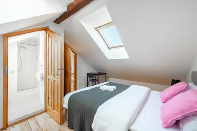 a bedroom with a bed and a shower at Spacious apartments near National theatre in Prague
