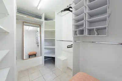 a walk in closet with a mirror and shelves at Spacious apartments near National theatre in Prague