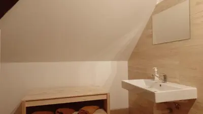 a bathroom with a white sink and a staircase at Ubytování Ždírec in Ždírec