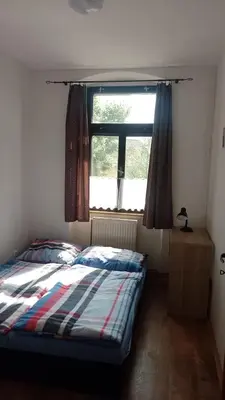 a bedroom with a bed in front of a window at Ubytování Ždírec in Ždírec