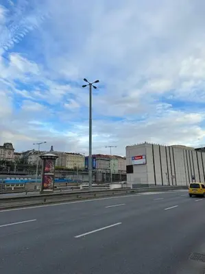 a yellow car driving down a street next to a building at Cozy apartment with garage in Prague