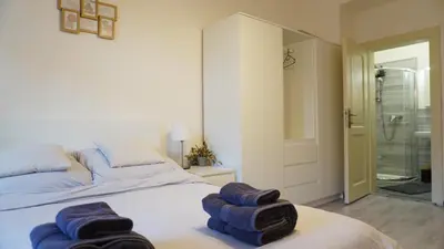 a bedroom with a bed with blue towels on it at Flat with Balcony and Garage in Prague