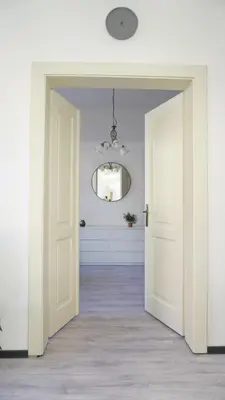 an open door into a hallway with a mirror at Flat with Balcony and Garage in Prague