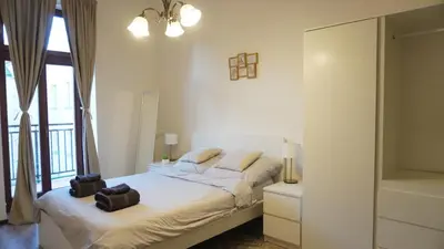 a bedroom with a bed with two towels on it at Flat with Balcony and Garage in Prague