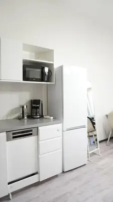 a kitchen with white appliances and a white refrigerator at Flat with Balcony and Garage in Prague