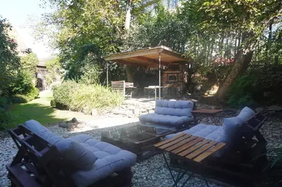a man with a backpack standing on a hill overlooking a river at Lavender Apartment - perfect for families! in Stranný