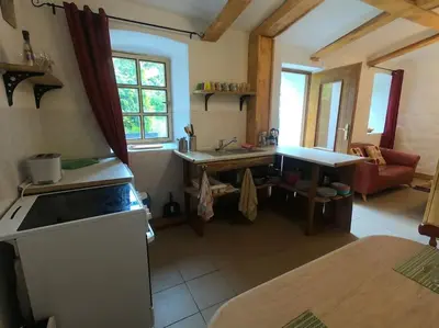 a kitchen with a sink and a table in a room at Lavender Apartment - perfect for families! in Stranný
