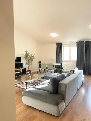 a living room with a couch and a table at Cozy Atmos Apartments in Prague