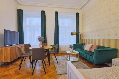 a living room with a green couch and a table at National Theatre Elegance Residence in Prague