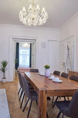 a dining room with a large wooden table and chairs at National Theatre Elegance Residence in Prague