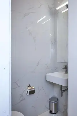 a white bathroom with a sink and a toilet at National Theatre Elegance Residence in Prague