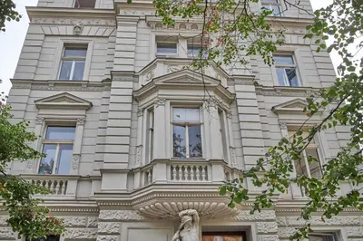 a tall building with a statue in front of it at National Theatre Elegance Residence in Prague