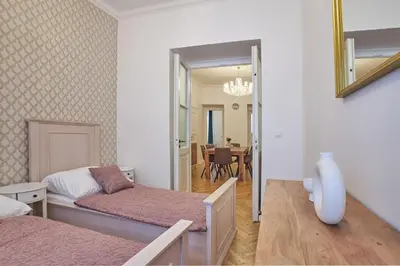 a bedroom with two beds and a mirror at National Theatre Elegance Residence in Prague