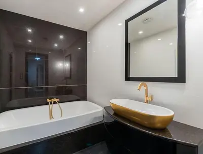 a bathroom with a tub and a sink and a mirror at Luxury apartment with terrace and garage in Prague